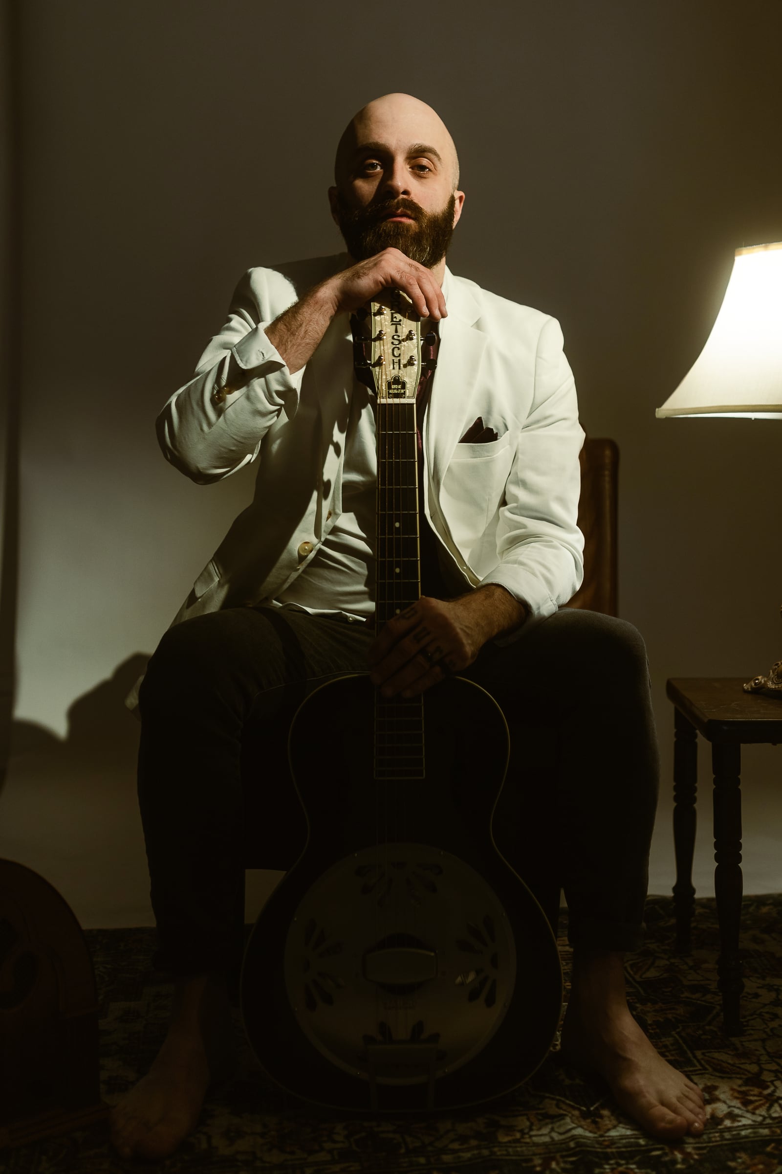 Joshua T. Hester holding a resonator guitar